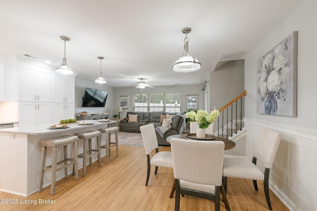 dining area featuring ceiling fan and light wood-type flooring