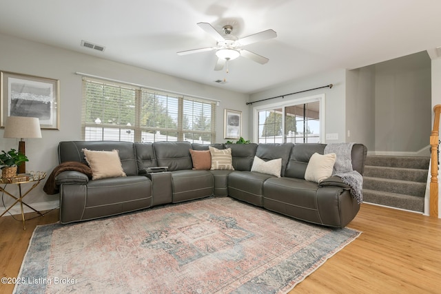 living room featuring hardwood / wood-style flooring and ceiling fan