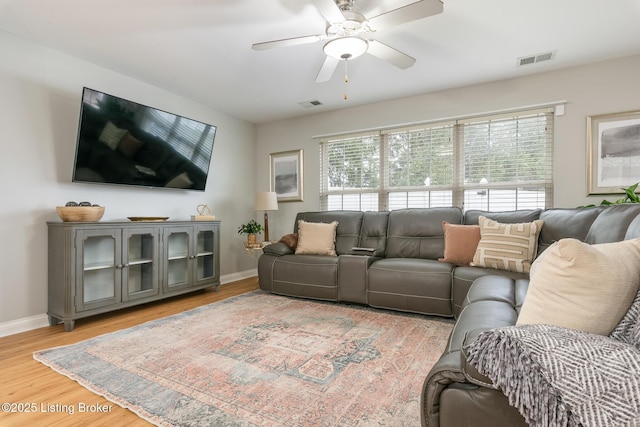 living room with hardwood / wood-style flooring and ceiling fan