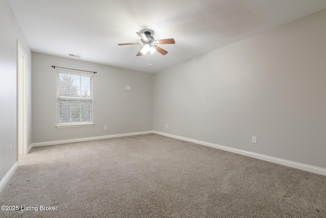 carpeted spare room featuring ceiling fan