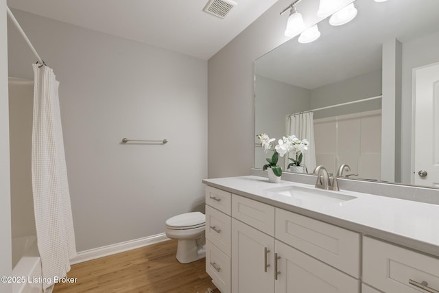 bathroom with vanity, hardwood / wood-style floors, and toilet