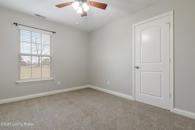 carpeted empty room with ceiling fan