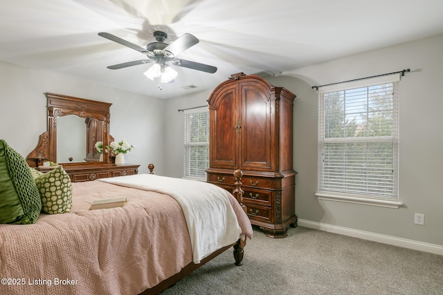 bedroom with ceiling fan, multiple windows, and light carpet