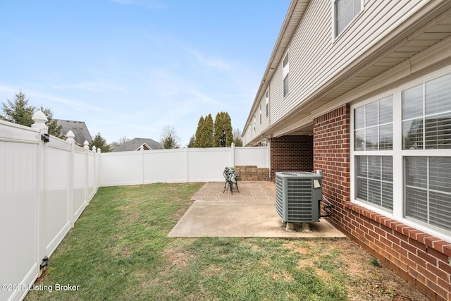 view of yard with central AC and a patio area