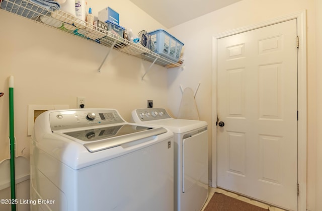 clothes washing area with washer and dryer