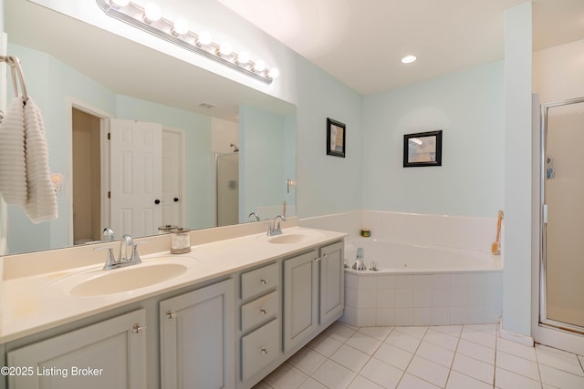 bathroom featuring vanity, plus walk in shower, and tile patterned flooring