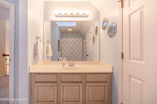 bathroom featuring vanity and curtained shower