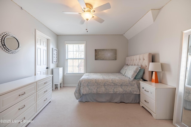 carpeted bedroom with ceiling fan and vaulted ceiling