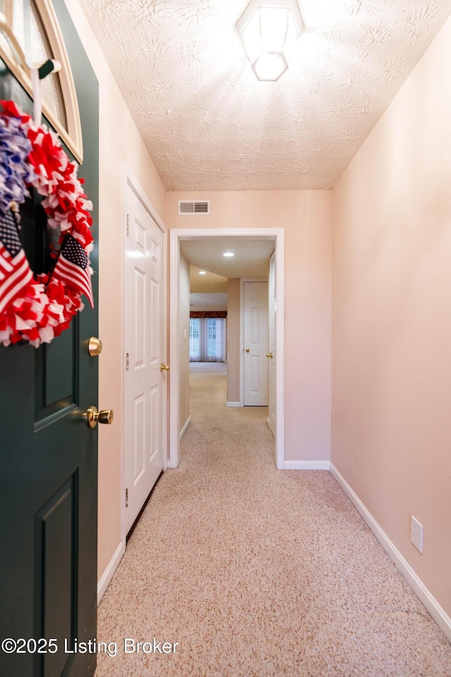 corridor with a textured ceiling