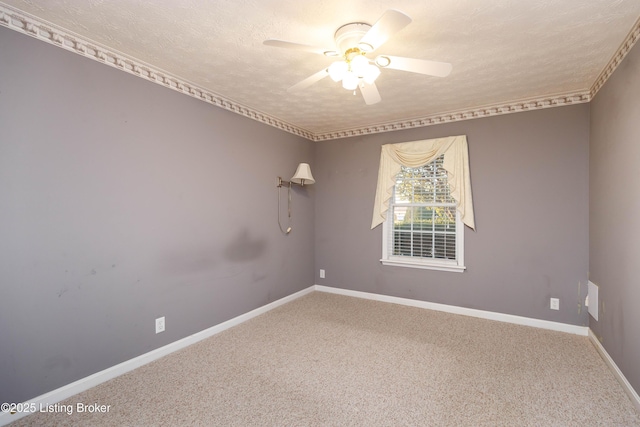 carpeted spare room featuring ceiling fan and a textured ceiling