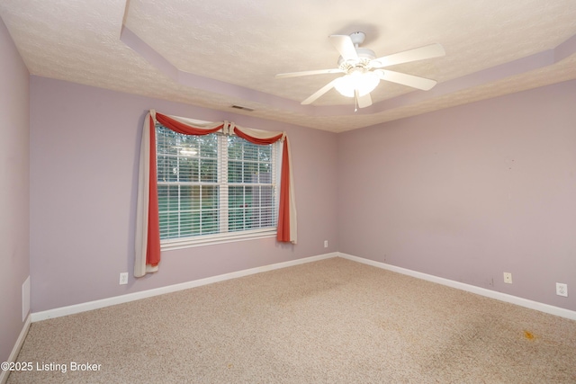 spare room featuring ceiling fan, carpet floors, and a textured ceiling