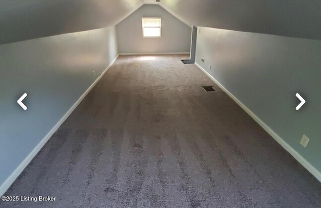 additional living space featuring lofted ceiling and carpet flooring