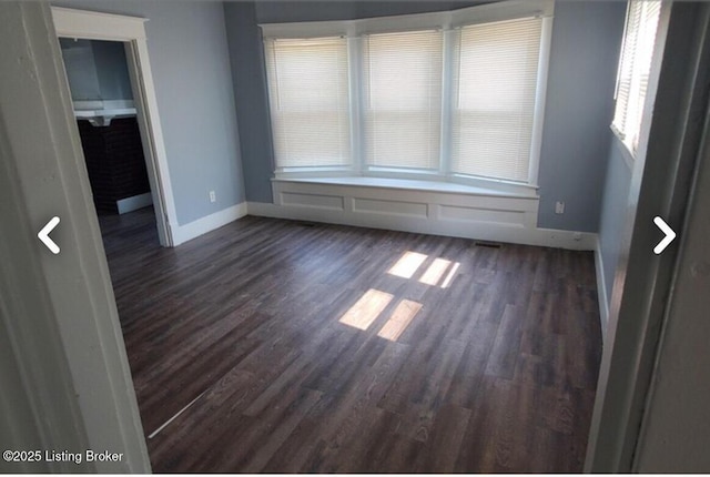 unfurnished room featuring dark hardwood / wood-style floors