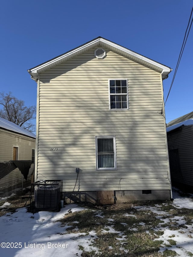 snow covered property with cooling unit