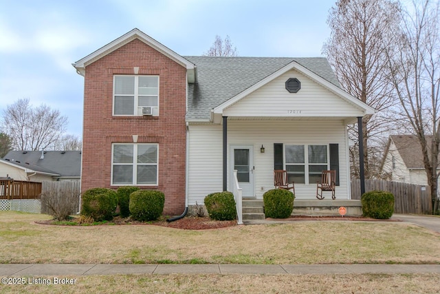 view of front facade with a front yard and covered porch