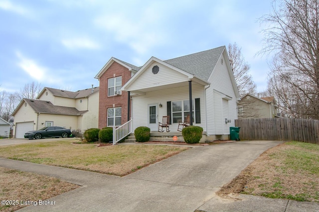 view of front of house featuring a porch, a garage, and a front lawn