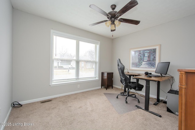 office space with ceiling fan and light carpet