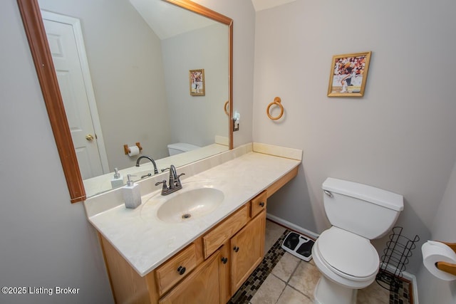 bathroom featuring tile patterned floors, vanity, and toilet