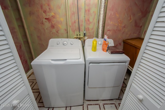 clothes washing area with washer and clothes dryer