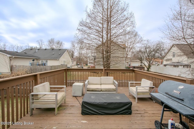 wooden terrace with grilling area and outdoor lounge area