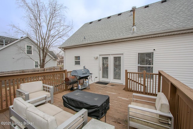 wooden deck with area for grilling and an outdoor living space