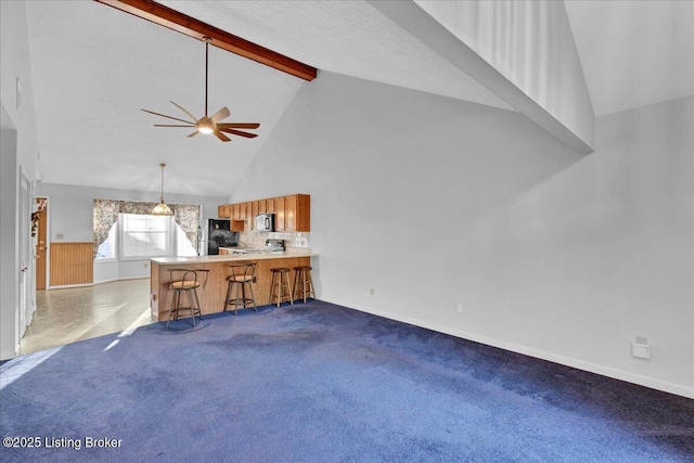 unfurnished living room featuring light carpet, ceiling fan, high vaulted ceiling, and beamed ceiling