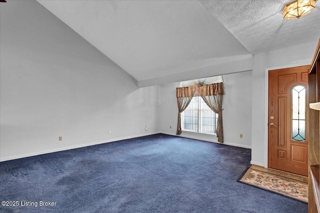 carpeted entrance foyer with lofted ceiling and a textured ceiling