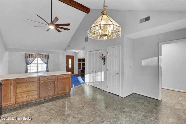 kitchen with beamed ceiling, high vaulted ceiling, ceiling fan with notable chandelier, and hanging light fixtures