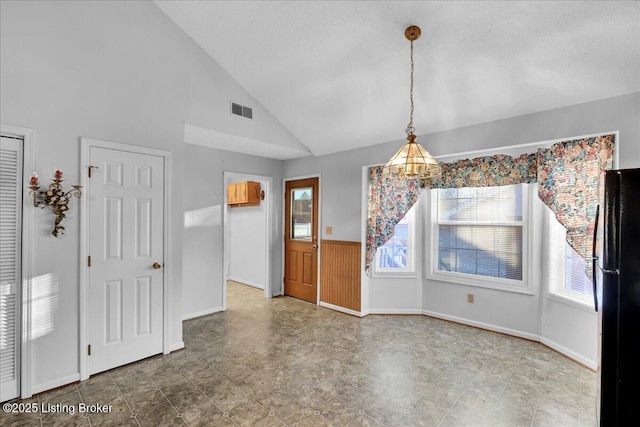 unfurnished dining area with lofted ceiling