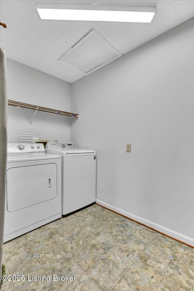 washroom with light tile patterned flooring and washing machine and clothes dryer