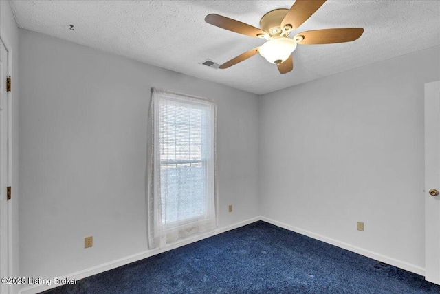 carpeted empty room featuring ceiling fan and a textured ceiling