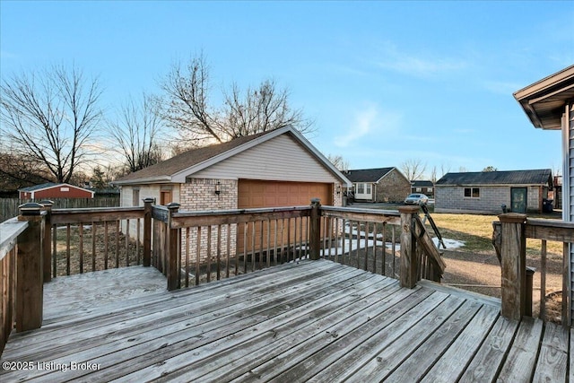 wooden deck with an outbuilding and a garage