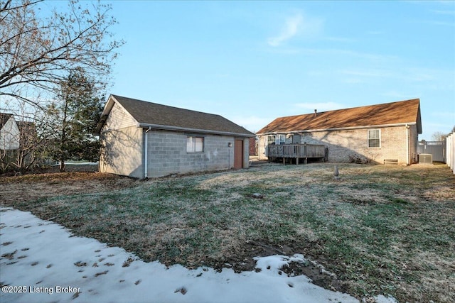 yard covered in snow with a wooden deck and central AC unit