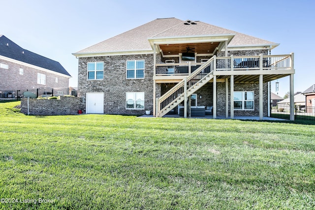 back of house featuring ceiling fan, a yard, and a deck