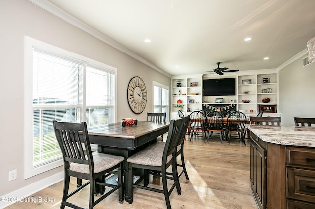 dining space featuring crown molding, ceiling fan, and light wood-type flooring