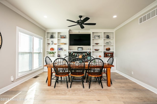 dining space with crown molding, ceiling fan, and light hardwood / wood-style flooring