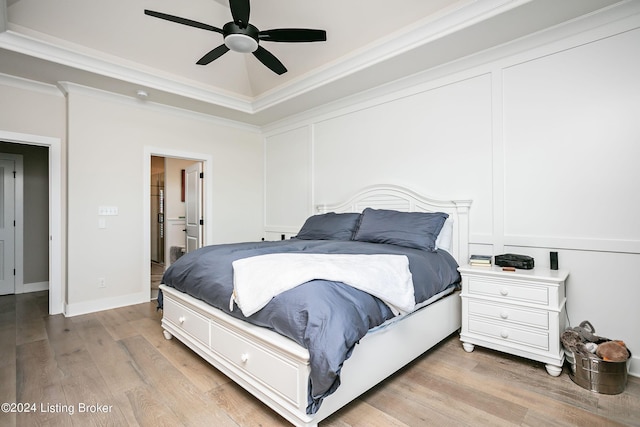 bedroom featuring crown molding, ceiling fan, and light hardwood / wood-style flooring