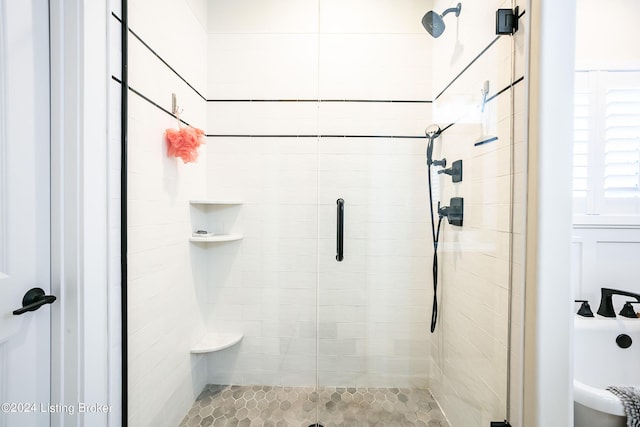 bathroom with a shower with shower door