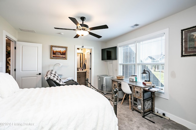 bedroom with light carpet, ceiling fan, and ensuite bath