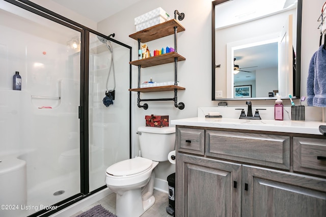 bathroom featuring vanity, an enclosed shower, ceiling fan, and toilet