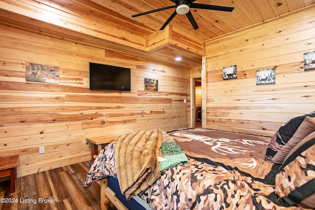 bedroom featuring wood-type flooring, ceiling fan, wood ceiling, and wood walls