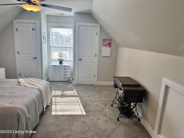 bedroom with light carpet, vaulted ceiling, visible vents, and baseboards