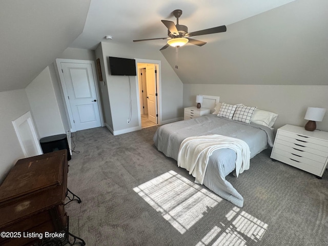 carpeted bedroom featuring a ceiling fan, lofted ceiling, and baseboards