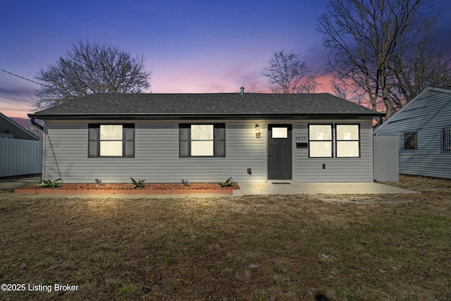 view of front of property with a lawn and a patio area