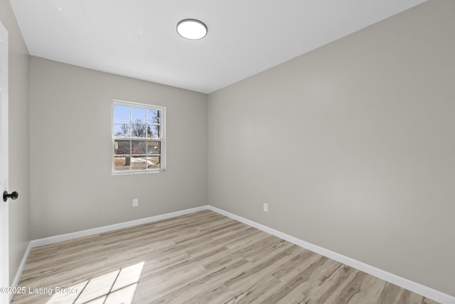 empty room with light hardwood / wood-style flooring