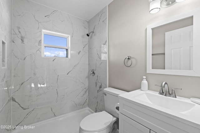 bathroom with vanity, toilet, and a tile shower