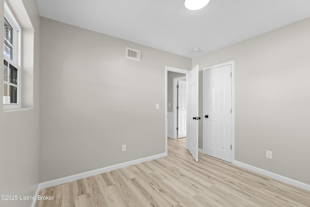 spare room featuring light hardwood / wood-style flooring