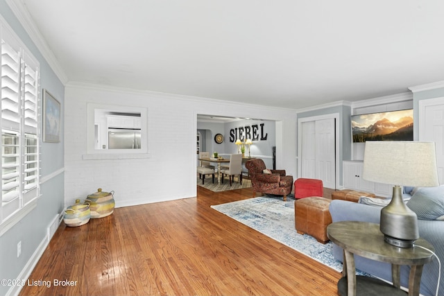 living room with ornamental molding and hardwood / wood-style floors