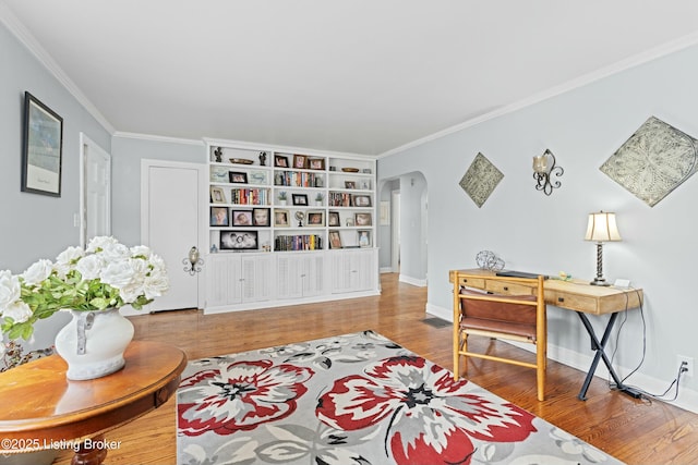 sitting room featuring hardwood / wood-style flooring and crown molding