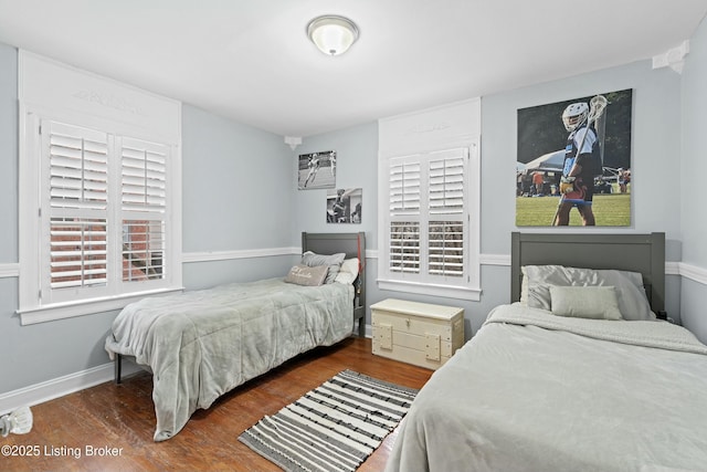 bedroom with dark wood-type flooring